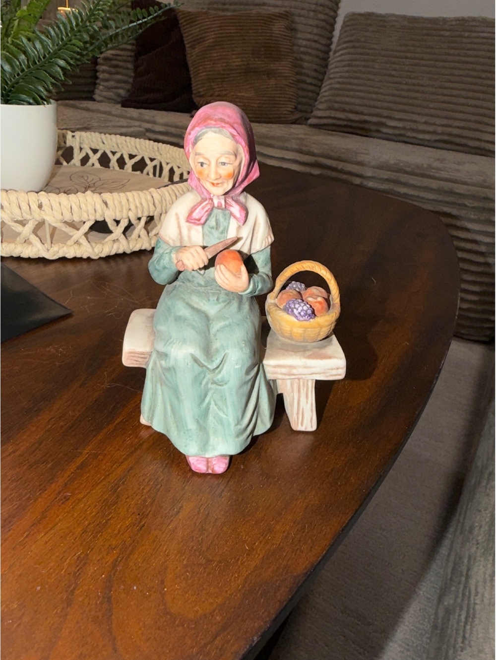 Seated Woman Figurine with Basket on Bench